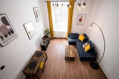 an overhead view of a living room with a couch and tables at Dajwor Residence Jewish Quarter WAWELOFTS in Kraków