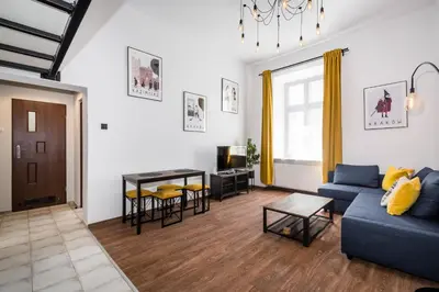 a living room with a couch and a table at Dajwor Residence Jewish Quarter WAWELOFTS in Kraków