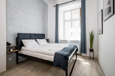 a bedroom with a bed and a window at Dajwor Residence Jewish Quarter WAWELOFTS in Kraków