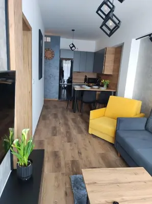 a kitchen with a wooden table and chairs at Silver 58 Zator in Zator