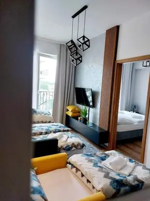 a living room with a table and chairs and a couch at Silver 58 Zator in Zator