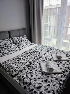 a pile of white towels sitting on top of a bed at Silver 58 Zator in Zator