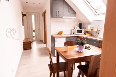 a kitchen and dining room with a wooden table at Apartamenty Home&Spa in Rabka