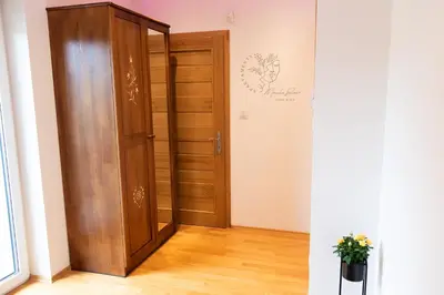 an open door in a room with a wooden closet at Apartamenty Home&Spa in Rabka
