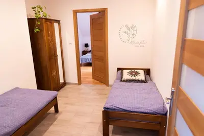 a hallway with two beds in a room at Apartamenty Home&Spa in Rabka