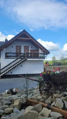 a house with a wheelbarrow in front of it at Apartamenty Home&Spa in Rabka