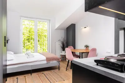 a bedroom with a bed and a table and chairs at Smart Apartments - Old Town & Main Train Station - by Upstairs in Kraków