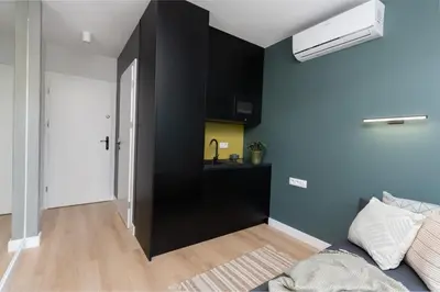 a living room with a black cabinet and a sink at Smart Apartments - Old Town & Main Train Station - by Upstairs in Kraków