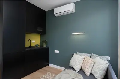 a bedroom with blue walls and a bed with pillows at Smart Apartments - Old Town & Main Train Station - by Upstairs in Kraków