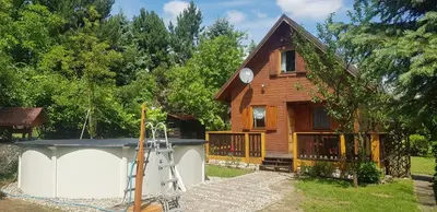 a house with a gazebo in front of it at Szyszka i Róża Domek na Jurze in Zelasko