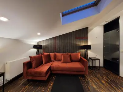 a living room with a brown couch in a room at Dada Premium Aparthotel in Kraków