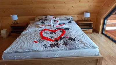 a bed with a heart made out of butterflies at Las Lorien - wynajem domków letniskowych in Roczyny
