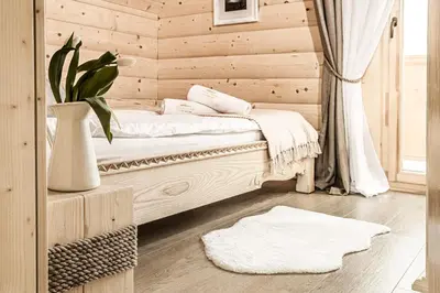 a bedroom with a bed and a vase with a plant at Pyrgielówka- chata Roztoki in Stryszawa