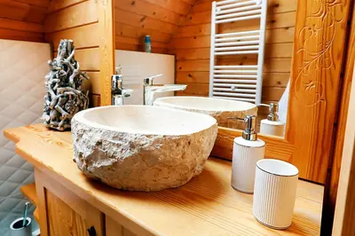 a bathroom with two sinks on a wooden counter at Pyrgielówka- chata Roztoki in Stryszawa