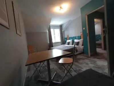 a living room with a table and a couch at Agroturystyka AMiG in Krzywopłoty