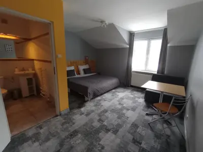 a group of pillows sitting on a bed in a room at Agroturystyka AMiG in Krzywopłoty