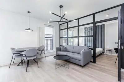 a living room with a couch and a table at Apartments Browar Kleparz by Noclegi Renters in Kraków