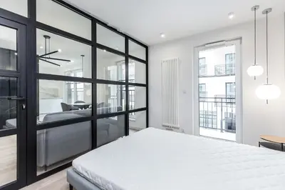 a bedroom with a bed and a view of a room at Apartments Browar Kleparz by Noclegi Renters in Kraków