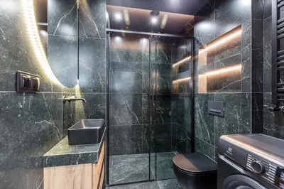 a bathroom with a shower with a sink and a toilet at Apartments Browar Kleparz by Noclegi Renters in Kraków