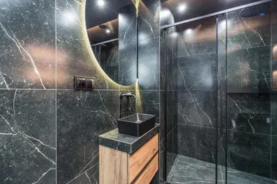 a bathroom with a sink and a shower at Apartments Browar Kleparz by Noclegi Renters in Kraków
