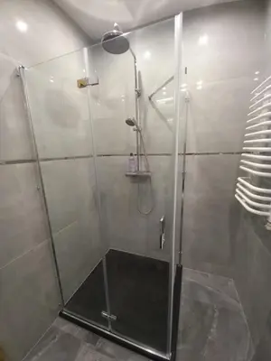 a shower with a glass door in a bathroom at APARTAMENT PRESTIGE OŚWIĘCIM in Oświęcim