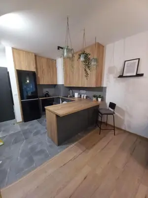 a kitchen with a wooden island in a room at APARTAMENT PRESTIGE OŚWIĘCIM in Oświęcim