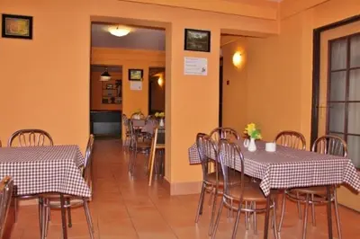 a dining room with two tables and chairs in a restaurant at Dom Wczasowy Anna in Rabka