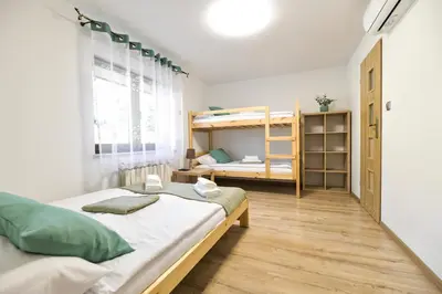 a bedroom with two beds and a bunk bed at Toffee House in Zator