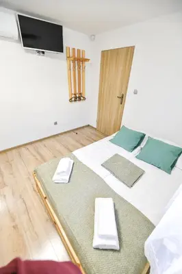 a room with a bed with two mats on it at Toffee House in Zator