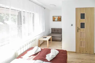 a bedroom with a bed and a window and a couch at Toffee House in Zator