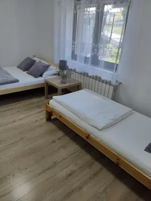 a room with two beds and a window at Toffee House in Zator