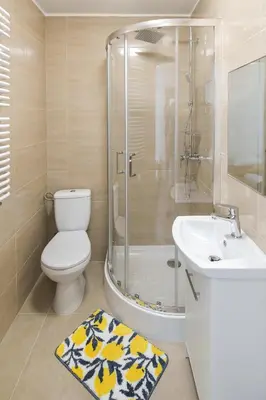 a bathroom with a toilet and a shower and a sink at Toffee House in Zator