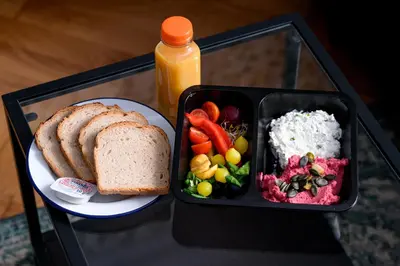 a tray of food with a plate of bread and a sandwich at Native Apartments Paulińska 20 Superior in Kraków
