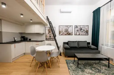 a living room with a couch and a table at Native Apartments Paulińska 20 Superior in Kraków