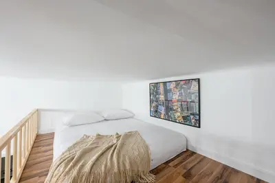 a white bedroom with a bed and a window at Native Apartments Paulińska 20 Superior in Kraków