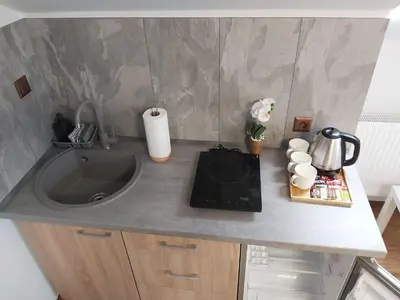 a kitchen counter top with a sink and a sink at Apartamenty MARGO in Chrzanów
