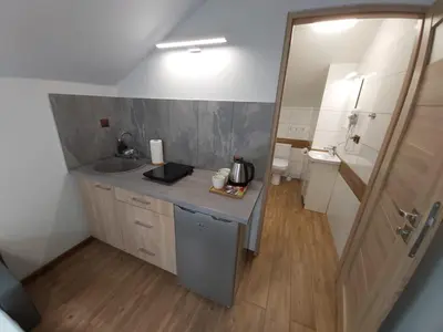 a small bathroom with a sink and a mirror at Apartamenty MARGO in Chrzanów