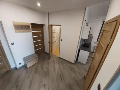 an empty room with a door and a hallway at Apartamenty MARGO in Chrzanów