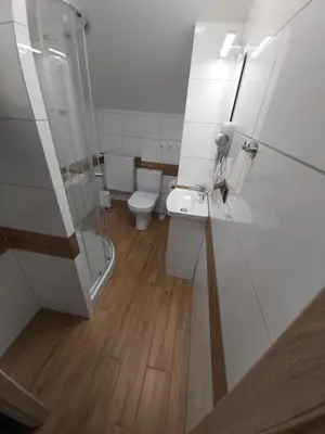 a bathroom with a toilet and a sink and a shower at Apartamenty MARGO in Chrzanów
