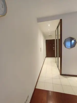 an empty hallway with a clock on the wall at JM Apartment Old Town Krakow in Kraków