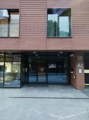 an empty building with glass doors and a speed limit sign at JM Apartment Old Town Krakow in Kraków