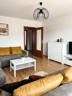 a living room with a couch and a table at Uroczy Apartament Pod Skarpą in Wadowice