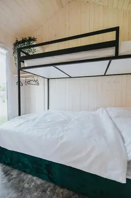 a white bed in a room with at Domki Energylandia Zator Przybradz in Przybradz