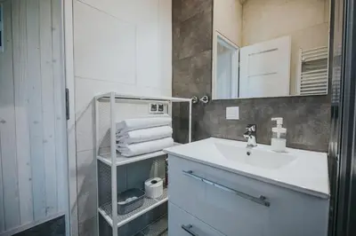 a bathroom with a sink and a mirror at Domki Energylandia Zator Przybradz in Przybradz