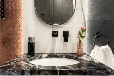 a bathroom with a sink and a mirror at Lovely flat Fabryczna Street AC free parking in Kraków