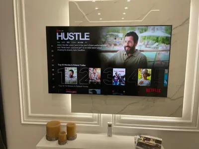 a tv hanging on a wall in a bathroom at Lovely flat Fabryczna Street AC free parking in Kraków