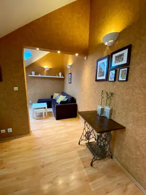a living room with a couch and a table at Dekoratoria Apartments in Kraków