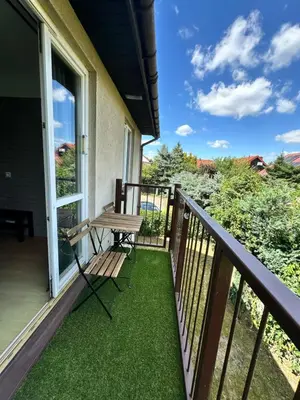 a balcony with a table and a bench on it at Dekoratoria Apartments in Kraków