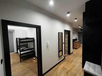a room with a hallway with a mirror and a room with a staircase at Apartament Helsinki in Zator