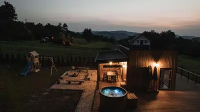 a small cabin with a pool in the yard at Tulichatki domki całoroczne in Tarnawa Dolna
